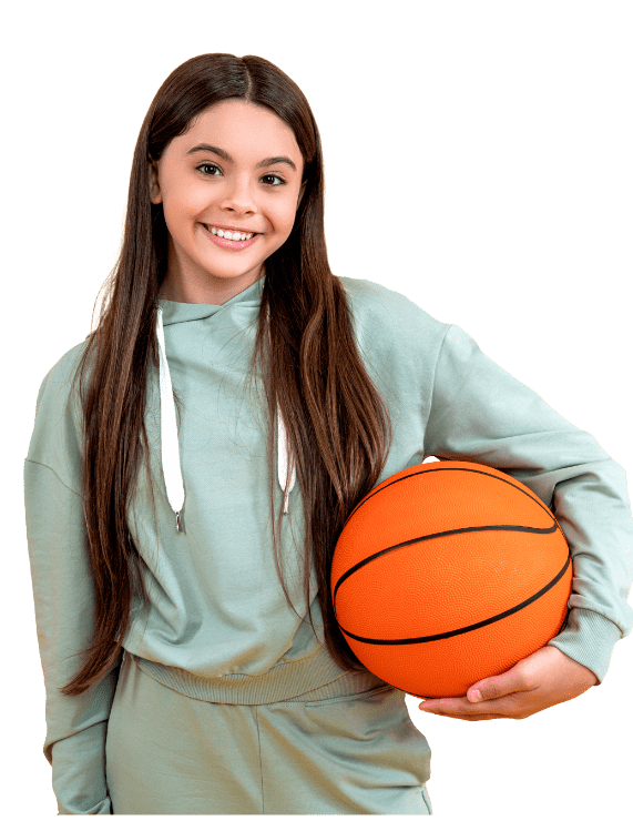 Win Orthodontics - Young teen girl holding a basketball smiling